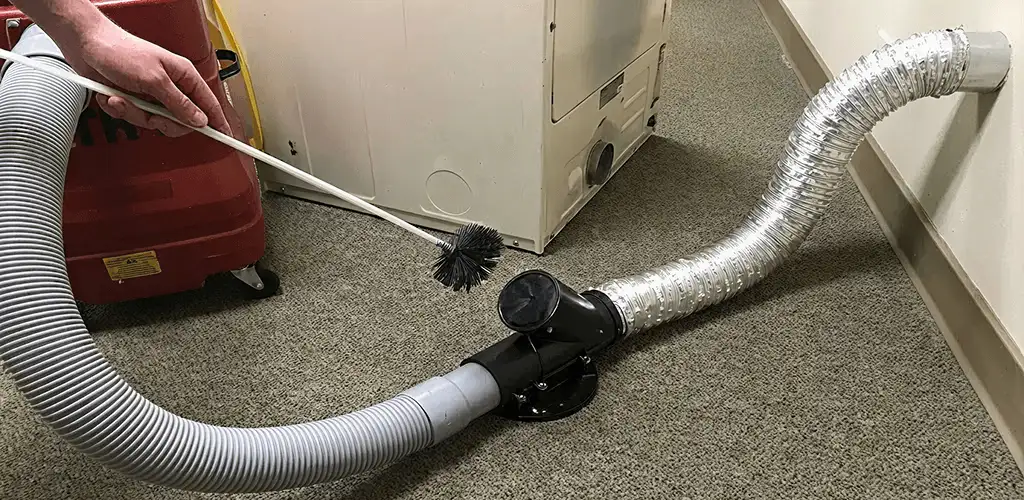 Dryer vent cleaning service removing lint from a dryer duct connection in Los Angeles, CA