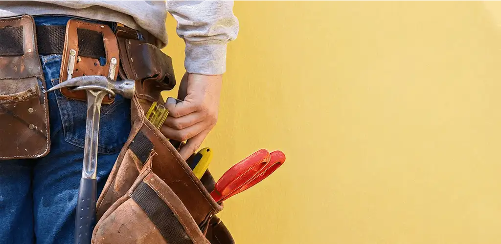 Handyman with tool belt ready for home repairs and maintenance in Los Angeles, CA