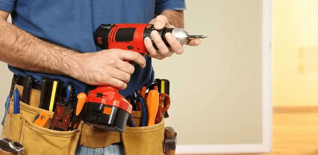 Handyman holding a power drill for home repairs and installations in Los Angeles, CA