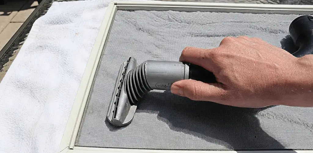 Window screen repair cleaning and fixing a damaged screen mesh in Los Angeles, CA